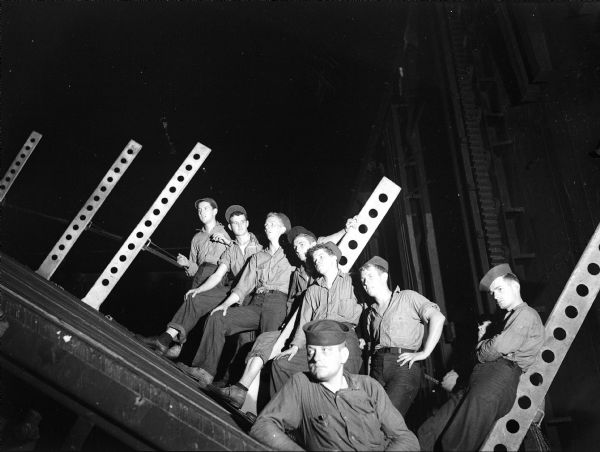 Crew of the U.S.S. <i>Franklin</i> watching a vaudeville performance from their hangar deck. The performance took place just seven days after the ship was hit by a Japanese bomber.