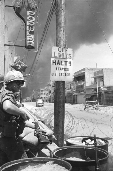 Guard at a restricted intersection of Henrique and Duarte streets at the border of the U.S. section of Santo Domingo, Dominican Republic.