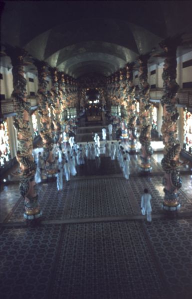 Elevated view of the interior of the Cao Dai temple at Tay Ninh, Vietnam during services.