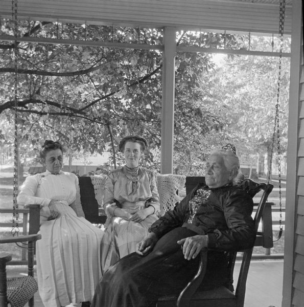 Harriet Millard, Mary E. Smith, and Harriet Millard Smith seated on a porch.