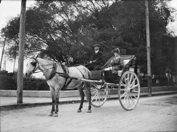 Mary E. Smith on a horse and carriage ride.