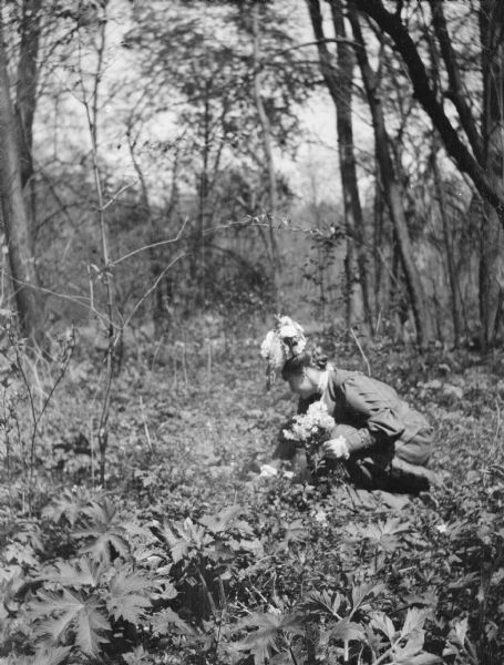 Mary E. Smith picking flowers.