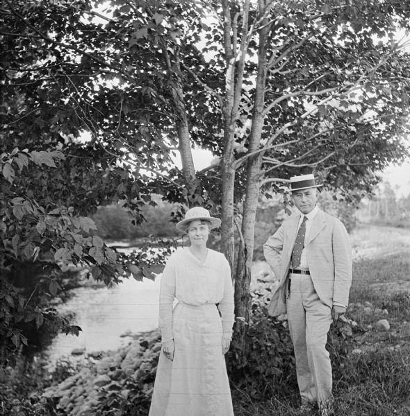 Dr. Joseph Smith and his wife, Mary, pose next to trees by a rivers edge.