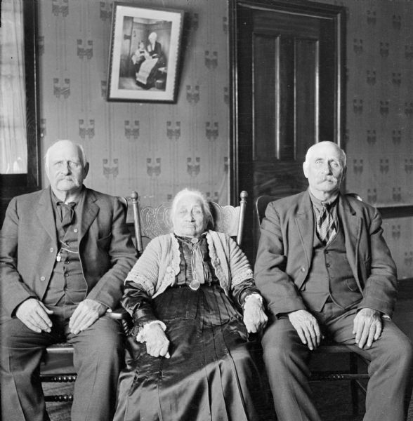 Indoor portrait of Harriet Crown Millard Smith sitting between two unidentified gentlemen.