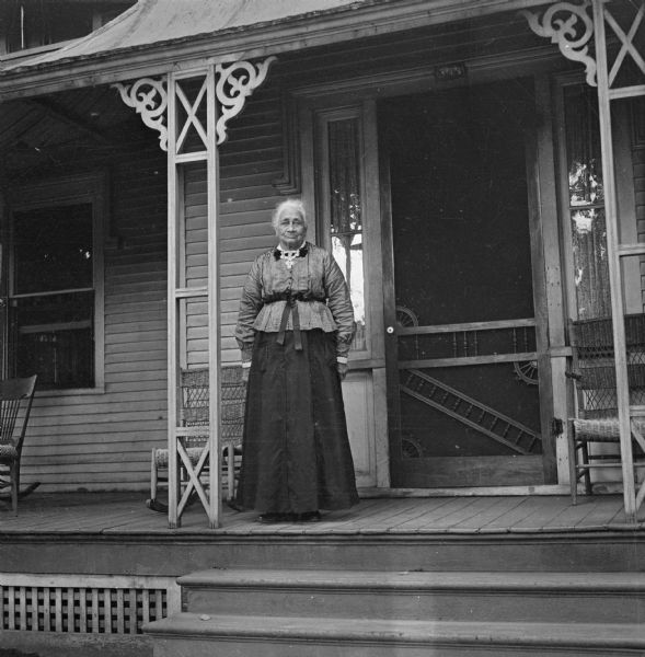 Harriet Millard Smith standing on the front porch of her home at 304 Fourth Street.