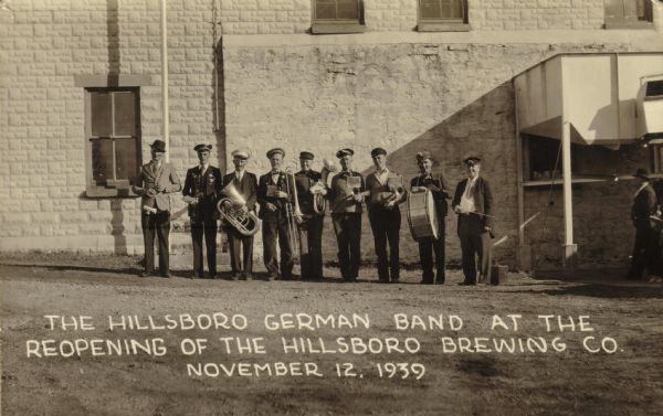 Outdoor group portrait of the Hillsboro German Band at the reopening of the Hillsboro Brewery by C.H. Phieffer. Includes, from left to right: Leo Liska, Rudolph Levy, Robert Janecek, Emil ___, Richard Hansberry, James Lein, Franklin Hansberry, Ernest Picha, and Edwin Shear.