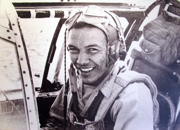 Portrait of Josh Sanford sitting in an airplane during WWII. Joshua was the child of a Ho-Chunk mother and Seneca Father. Sanford served in the Army Air Corps during WWII and is credited with being the only Native American pilot to serve in China. Sanford eventually reached the rank of Captain, won the Fly Cross Award, and took part in at least 74 combat missions.
