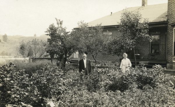 Otto and Mathilda Hammer in their large garden outside their home. Otto Hammer helped build the first sawmill in Hillsburo in 1855.