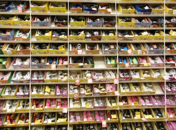 A large rack of kid's shoes at Payless Source, Shopko.