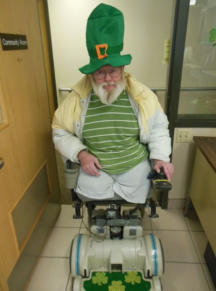 Michael Pierce Murphy in his giant leprauchan hat and decorated scooter wheelchair at Becker Plaza.