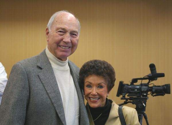 Bart Starr (Pro Football Hall of Famer and Former Green Bay Packer quarterback and coach) and his wife, Cherry Starr, posing for a photo at a Boy Scouts of America press conference at the Marriott Hotel. A video camera is on the right.