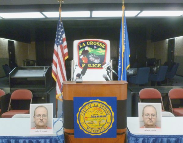 Press conference podium area in the City Hall for a double-homicide case, with main suspect (later convicted), Jeffrey Lepsch, pictured twice. American and Wisconsin flags are displayed on each side of the podium, and on the front is the seal of the City. Behind the podium is the seal of the Police force. Several microphones await a speaker.