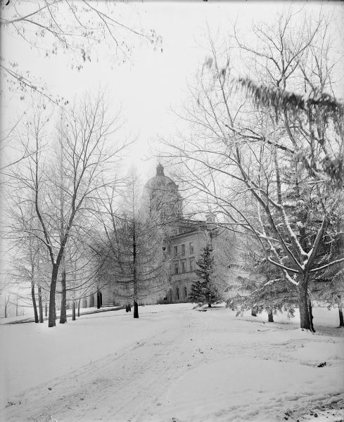 Winter scene of snow-covered path outside Main Hall (Bascom Hall) on the University of Wisconsin-Madison campus.