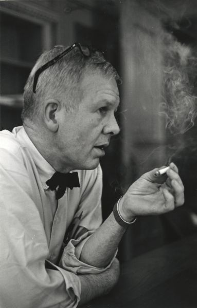 Informal profile portrait of Paul Vanderbilt smoking a cigarette.