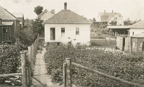 Rear view of the first parsonage occupied by the Reverend Mr. Row.