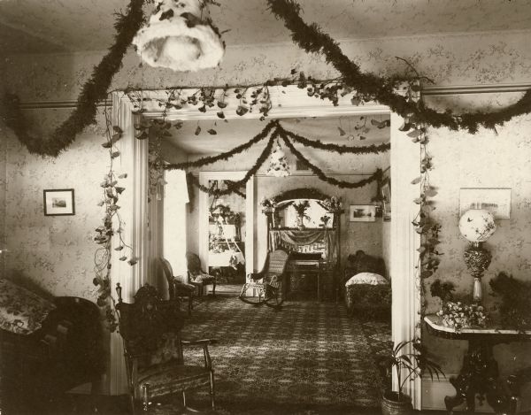 Interior of the John A. Landfair home, showing floral decorations for the wedding of Kate Landfair and Marvin B. Rosenberry, later Chief Justice of the Supreme Court of Wisconsin.