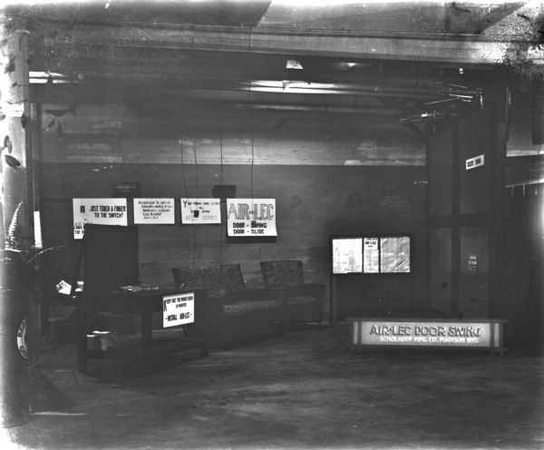 Interior view of the Schoelkopf Air-Lec Manufacturing facility at 320 N. Third Street. A number of signs on the back wall describe the Air-Lec's features.