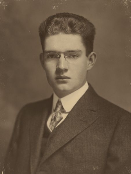 Quarter-length studio portrait of nineteen-year-old Ernst Conrad Schmidt, grandson of Chicago brewer Conrad Seipp, and an owner of Black Point Estate. He is wearing a suit and tie, and pince nez glasses.