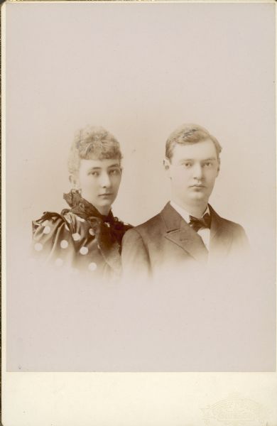 Dr. Otto L. and Emma Sibylla Seipp Schmidt pose for a vignetted head and shoulders portrait around the time of their marriage. Otto wears a suit and tie. Emma's dress has large polka dots. Emma was a daughter of Chicago brewer Conrad Seipp, and an owner of Black Point Estate.