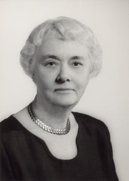 Head and shoulders portrait of Alma Schmidt Petersen (1894-1989), granddaughter of Chicago brewer Conrad Seipp, who, with her husband, William F. Petersen was an owner of Black Point Estate. She is wearing a simple black blouse and gold choker. Mrs. Petersen was a graduate of Mt. Vernon Seminary, now part of George Washington University, and a philanthropist and patron of the arts. She was a president of Chicago's Hull House Association.