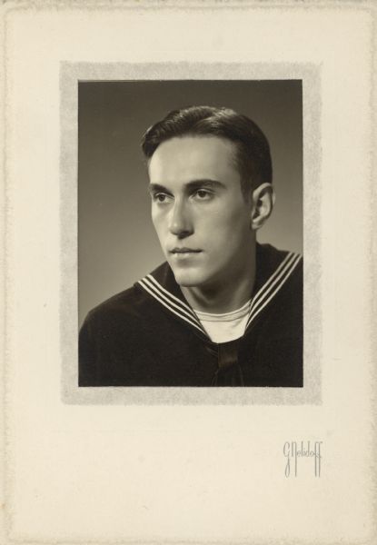 Head and shoulders studio portrait of Conrad Petersen (1924-2013) in his navy dress blues uniform. He was a U.S. Navy Reserve Ensign, 1943-1946. His parents, Alma and William F. Petersen, were owners of Black Point Estate.