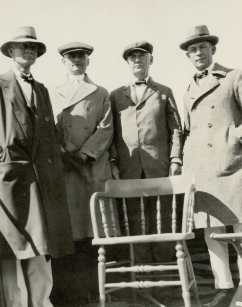 Dr. Otto Schmidt (1863-1935), second from right, poses behind a captain's chair with three other officials of the Inland Lakes Yachting Association (ILYA) at the ILYA Regatta. Dr. Schmidt was president of the ILYA for 22 years.