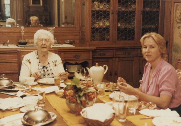 Alma Schmidt Petersen, left, enjoys a meal with her niece (by marriage), Ilze Reese, in the dining room of the main house at Black Point Estate. This photograph may have been taken around the time of a family gathering to celebrate Alma's eighty-eighth birthday, July 11, 1982.