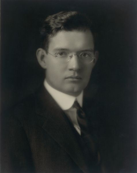 Quarter-length studio portrait of Ernst Conrad Schmidt (1893-1977), son of Emma and Otto Schmidt and grandson of Chicago brewer Conrad Seipp. He is wearing a dark pinstripe suit, white shirt and necktie.