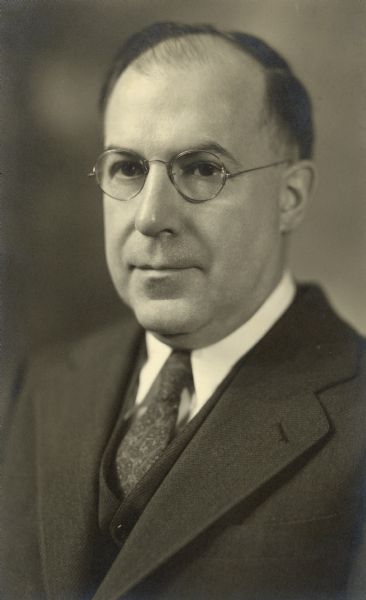 Quarter-length studio portrait of Dr. William F. Petersen (1887-1950).  He is wearing a dark suit with a vest and necktie. Dr. Petersen, with his wife, Alma Schmidt Petersen, was an owner of Black Point Estate. Their son, William O. Petersen, donated the estate to the State of Wisconsin in 2005.