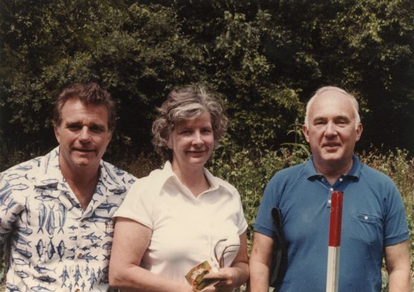 William O. Petersen, right, poses with his wife, Jane Browne Petersen, and cousin Ernst Schmidt Reese. Jane holds a package of cucumber seeds and a hand cultivator.