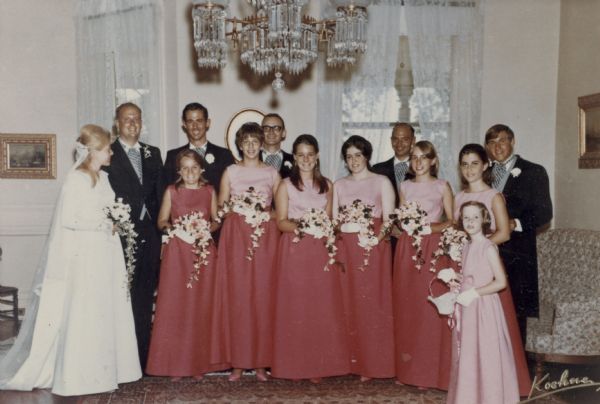 Bride Catherine Bakieff Petersen and groom Peter Seipp Goltra, left, pose with their wedding party under the crystal chandelier in the music room at Black Point Estate. Catherine and Peter are distant cousins, each being a great-great-great-grandchild of Chicago brewer Conrad Seipp. Seipp built the main house at Black Point Estate in 1888.