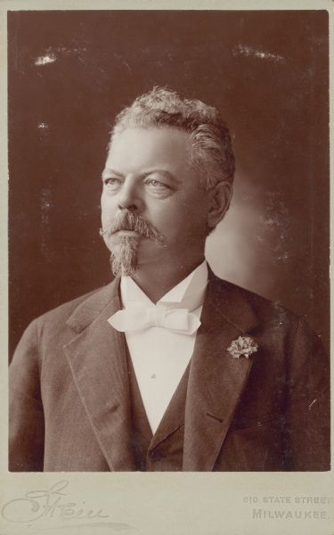 Quarter-length studio portrait of Frederick Pabst (1836-1904). He is wearing a suit with white tie and a carnation boutonnierre.