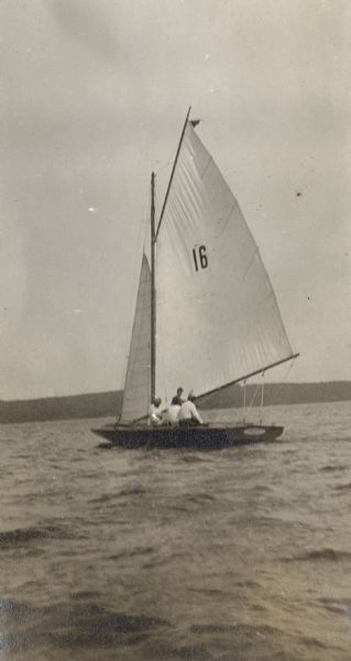View across water towards the <i>Senta</i>, owned and skipped by Dr. Otto Schmidt, on Lake Geneva near the Lake Geneva Yacht Club just before the start of the Sheridan Race.