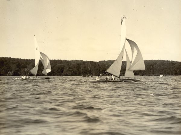 The <i>Senta II</i>, right, leads the <i>Deltox</i>, of Oshkosh, in one of the races at the Inland Lake Yachting Association Regatta at Lake Geneva. Both boats are flying spinnakers. The <i>Senta II</i> was owned by Dr. Otto L. Schmidt,  who was an owner of Black Point Estate.