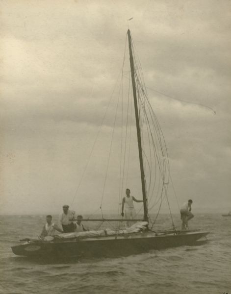 A description of this photograph written by Ernst Schmidt reads: "The 'Senta' with the anchor out shortly after the storm had hit. I am on the after deck — Father [Dr. Otto L. Schmidt] is standing up in the cock-pit... I think it is Charlie Fisher standing at the mast, who is on the forward deck I do not know." The Schmidts were competing in the Class A race at the Inland Lake Yachting Association Regatta on Lake Winnebago.
