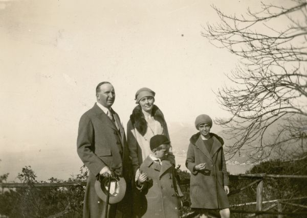 William Conrad Seipp, Jr., left, and his daughter Melita, far right, pose with Alma Schmidt Petersen and her son Conrad at an overlook above Portofino Bay. Members of the extended Seipp family were on a tour of Europe.