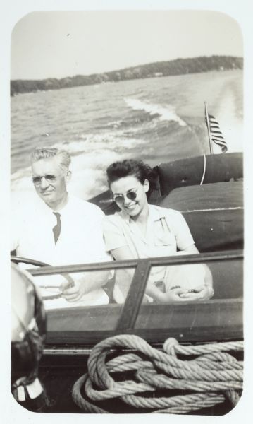 View from front of motorboat of Ernst Schmidt (driving) and Catherine Schuelke enjoying an outing on Geneva Lake.