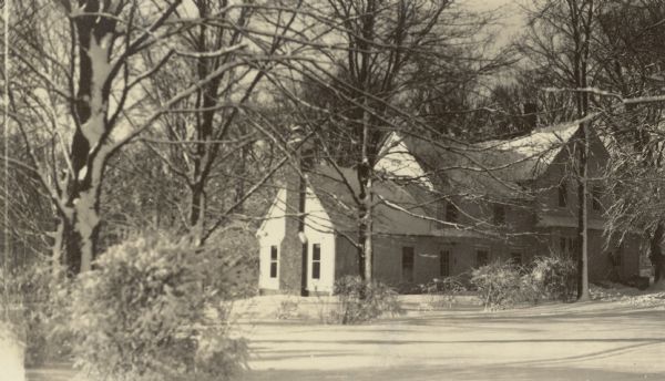A winter view of the farmhouse at Black Point Estate after completion of an addition, seen on the left. The addition included a full two-story portion as well as the lower portion with large brick chimney. The farmhouse was used primarily by Ernst Schmidt, a grandson of Conrad Seipp who founded Black Point in 1888.