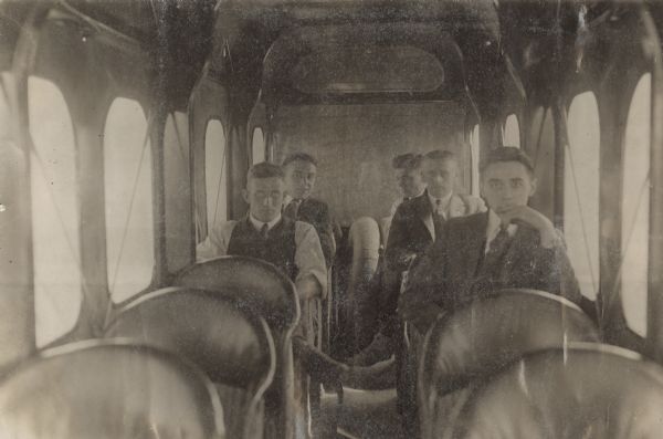Five men sitting inside a Lawson Air Liner. 