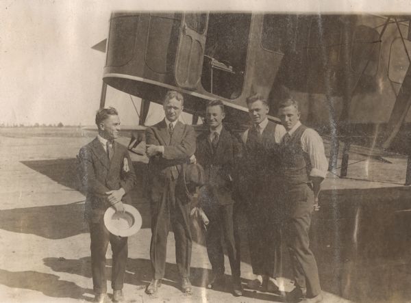 Group portrait of Alfred Lawson and the team that built the first Lawson Air Liner. From the left: Vincent J. Burnelli, chief engineer; Lawson; Charles L. Cox, pilot; Andrew Surini, mechanic; Carl Schory, mechanic. 