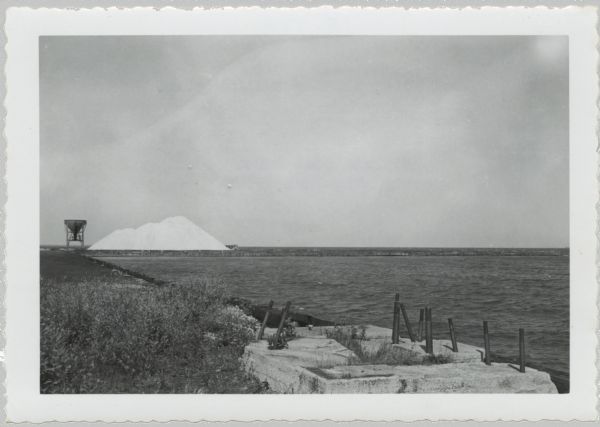 View from shoreline of dock site towards Lake Superior, showing sulphur pile and a large chute in the background.
