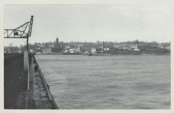 View of Port Washington Harbor from Wisconsin Electric Power Company wharf. The city is in the background along the shoreline.