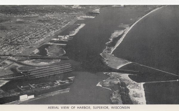 Aerial view of harbor, with shipyards in the foreground and Superior in the background. Caption reads: "Aerial View of Harbor, Superior, Wisconsin."