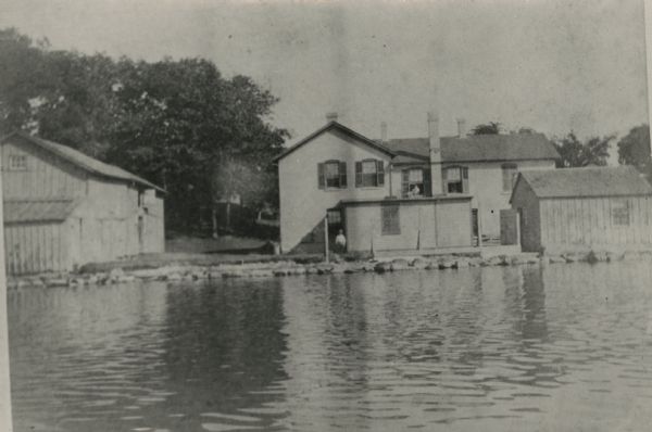 View across water towards where brothers John and August Lindstrom had a pop factory at 409 N. Blair Street during the 1870s and 1880s. They lived above the factory until they built a house across the street. The entrance was at 524 E. Gorham Street.