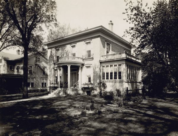 Exterior view across lawn of the Italianate house at 234 Langdon Street. The house was built in 1875 and had numerous additions and remodeling jobs.