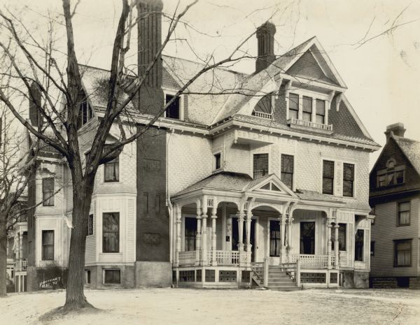 Exterior view of the home of John C. Spooner. The house is a Queen Anne style at the corner of Langdon and Henry Streets. The address was possibly 619 Henry, later replaced by the Spooner Apartments building. Elsewhere the address is given as 150 Langdon Street. 150 Langdon Street is the location of the Halle Steensland House built in 1892, and was there until at least 1927 when an addition was built.