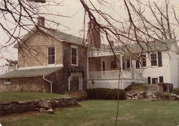 This is number one in Stanley Hanks' collection of four prints of the Keystone House in Shorewood. This historic stone farmhouse, at 901 University Bay Drive, was renovated by Freda Keys Winterble. The house was named "Keystone" after her family. The farmhouse was built by William J. Petherick in 1853. The Wisconsin Alumni Research Foundation bought it in 1967 and donated it to the University of Wisconsin-Madison. It is the home of the Max Kade Institute for German American Affairs.
