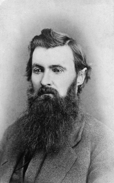 Quarter-length portrait of Frank Barnes, perhaps in his mid-thirties. He has dark hair, a moustache and a full, long beard. He is wearing a suit and vest. Frank Barnes owned and operated the Angle Worm Station on Lake Monona.