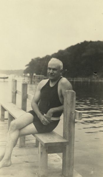 C.B. (Chandler Burnell) Chapman, a good friend of Stanley Hanks from their college days, posing while sitting on a bench on the dock before his swim across Lake Mendota to Picnic Point from the foot of North Carroll Street.