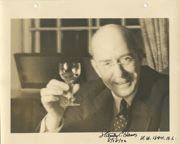 Portrait of Stanley Hanks (born on August 18, 1872), raising a glass in a toast. He is wearing a dark suit and dotted tie. Stanley Hanks, a prominent Madison realtor and photograph collector, graduated from the University of Wisconsin in 1894, although he remained for advanced degrees.